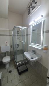 a bathroom with a shower and a sink and a toilet at Paleo Inn Hotel in Paleokastritsa +43 photos