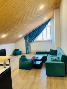 a living room with a green couch and a table at Tbilisi Vera in Tbilisi City