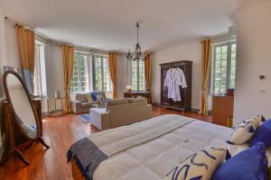 a bedroom with a large bed and a living room at Château de Taradel in Taradeau +64 photos