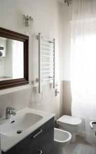 un bagno con lavandino, WC e finestra di SanSi a Milano Altre 18 foto