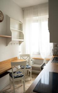 una cucina con tavolo e sedie e una finestra di SanSi a Milano