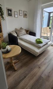 a bedroom with a bed and a table in a room at Fuchsbau Voßwinkel in Arnsberg