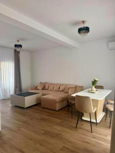 a living room with a couch and a table at Vila Lux Braila in Brăila