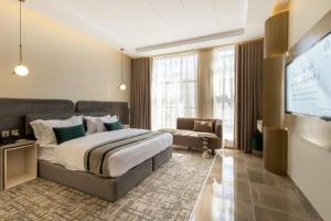a bedroom with a bed and a flat screen tv at فندق فاتوران 2 in Medina