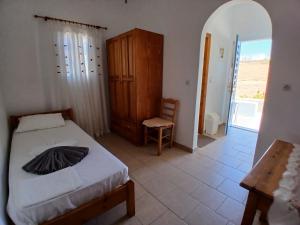 a bedroom with a bed and a wooden cabinet at Fragos Apartments in Santa Maria
