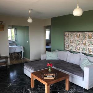 a living room with a couch and a table at Beautiful Farm House in Filiatra +39 photos