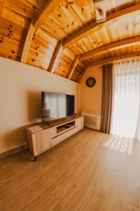 a large living room with a flat screen tv at Durmitor Horizons in Žabljak
