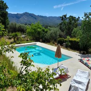 a swimming pool with a view of the mountains at La Forge in Aubagne