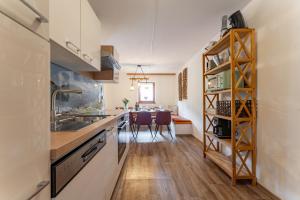 a kitchen with a sink and a dining room at Ferienhaus Pichl in Bruck an der Großglocknerstraße