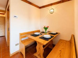 a dining room with a wooden table and chairs at Hostdomus - A3-07 in Grange Sises