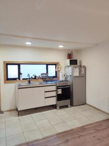 a kitchen with a sink and a refrigerator at Casa Giovanna in Puerto Natales +10 photos