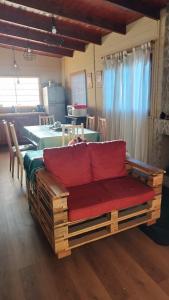 a wooden bench with a red seat in a room at La Soñada in San Javier
