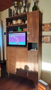 a wooden cabinet with a tv in a room at La Soñada in San Javier