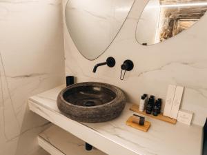 a bathroom with a sink and a mirror at KL , Cozy Suite II in Kithnos +24 photos