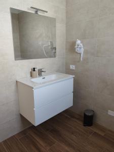 a bathroom with a white sink and a mirror at PiaveHome in San Donà di Piave +23 photos