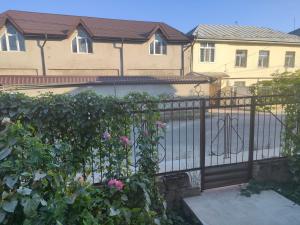 a black iron fence in front of a house at Bright Modern Suite in Quba