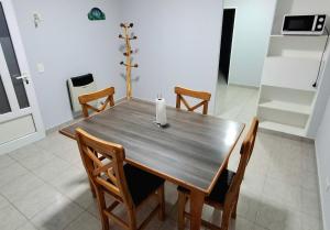 a dining room table with chairs and a candle on it at Ayinmai in Trelew