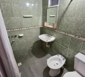 a bathroom with a toilet and a sink at Ayinmai in Trelew