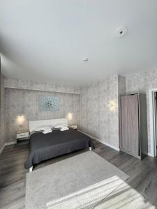 a bedroom with a large bed in a room at Готель Elisavetgrad in Kropyvnytskyi