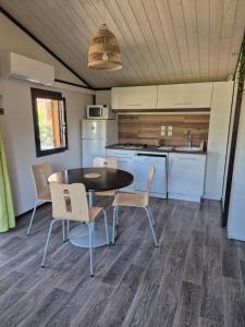 a kitchen and dining room with a table and chairs at Chalet a louer avec piscine in Solliès-Toucas