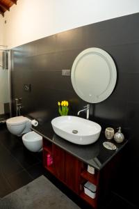 a bathroom with two sinks and a large mirror at Regal Retreat in Mahawatta
