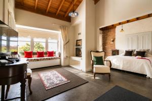 a bedroom with a bed and a desk and a window at Alacati Kostem Hotel - Special Category in Alaçatı