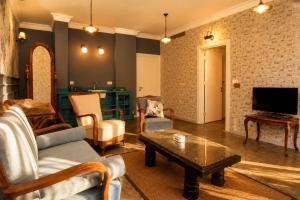 a living room with a couch and a table at Alacati Kostem Hotel - Special Category in Alaçatı