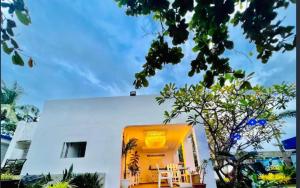 a yellow building with a table and chairs in front of it at The Beach House and Bar in Roxas City