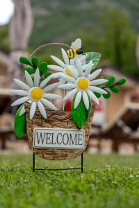 a basket of flowers with a sign that says welcome at Etno Selo Grabovicka Jutra in Cetinje