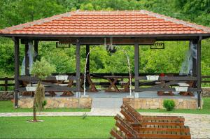 a gazebo with a picnic table in a park at Etno Selo Grabovicka Jutra in Cetinje