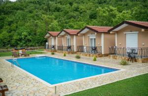 a swimming pool in the yard of a house at Etno Selo Grabovicka Jutra in Cetinje