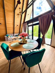a dining room with a table and chairs and a couch at Nature View Breaza in Breaza de Sus +31 photos
