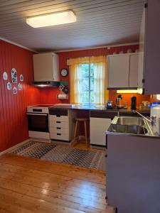 a kitchen with a sink and a counter top at Rorbu in Nusfjord, Lofoten in Nussfjord +8 photos