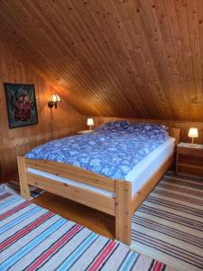 a bed in a room with a wooden ceiling at Rorbu in Nusfjord, Lofoten in Nussfjord