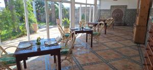 a dining room with tables and chairs on a patio at Le Refuge in Larache