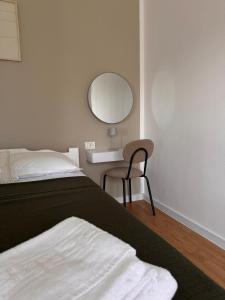 a bedroom with a bed and a mirror and a chair at Vila Happy House in Costinesti +2 photos