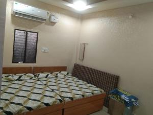 a bedroom with a bed and a window at Nandan Palace in Godarpura