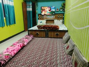 a bedroom with a bed and a tv in it at Nandan Palace in Godarpura