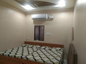 a bedroom with a bed and a air conditioner at Nandan Palace in Godarpura