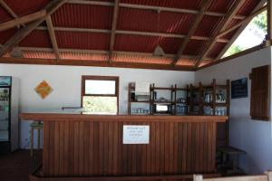 a bar in a building with a sign on it at Statia Lodge in Oranjestad