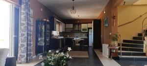 a room with a kitchen and a living room at La Vatura in Gialova