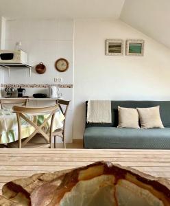 a living room with a couch and a table at Puebla :) in A Pobra do Caramiñal