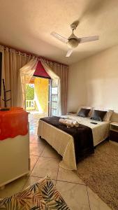 a bedroom with a bed and a ceiling fan at Suíte privativa - Centro Guararema in Guararema