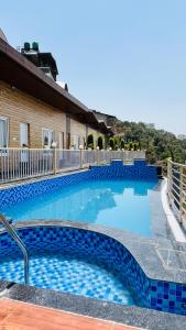 a large swimming pool with blue tiles on it at Msk Hotel & Restaurant in Narendranagar