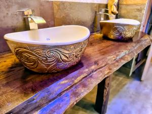 a bathroom with a sink on a wooden counter at Domki Gama-Spa in Władysławowo