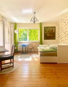 a bedroom with a bed and a table and chairs at Studio im Haus Amselgarten in Kolonie Tannenhof