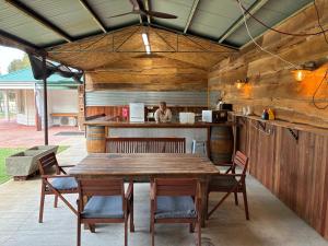 a wooden table and chairs in a kitchen at Yurts at Yelverton in Yelverton