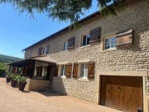 a large brick building with a garage at Domaine Bassy in Saint-Gengoux-de-Scissé
