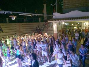 a group of people dancing in front of a crowd at Camping Calabrisella in Borgia