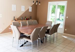a dining room with a wooden table and chairs at La Maison Du Vigneron in Gaillac